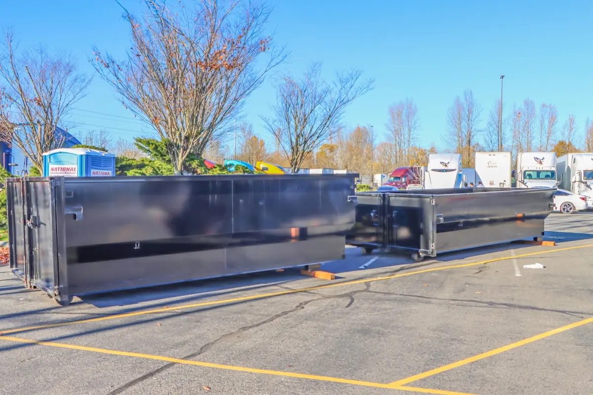 Professional dumpster rental service with roll-off container on residential driveway in Smithville